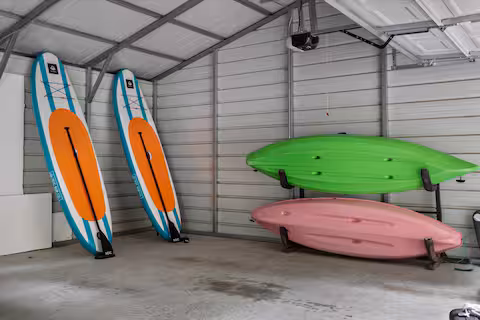 Kayaks on the shoreline at the Virgilina Lake House, a Bello Homes lakefront rental