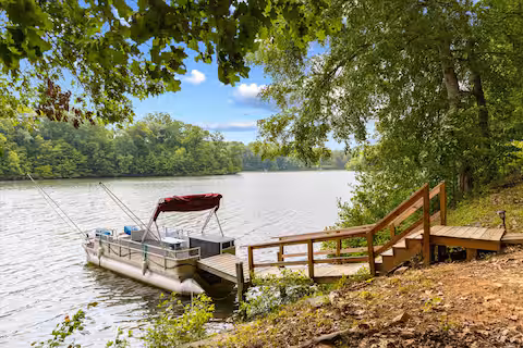 Pontoon boat on the lake at the Virgilina Lake House short-term rental