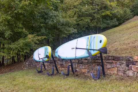 Paddleboards by the lake at the Zane Home, a Bello Homes lakefront rental in Leasburg, NC